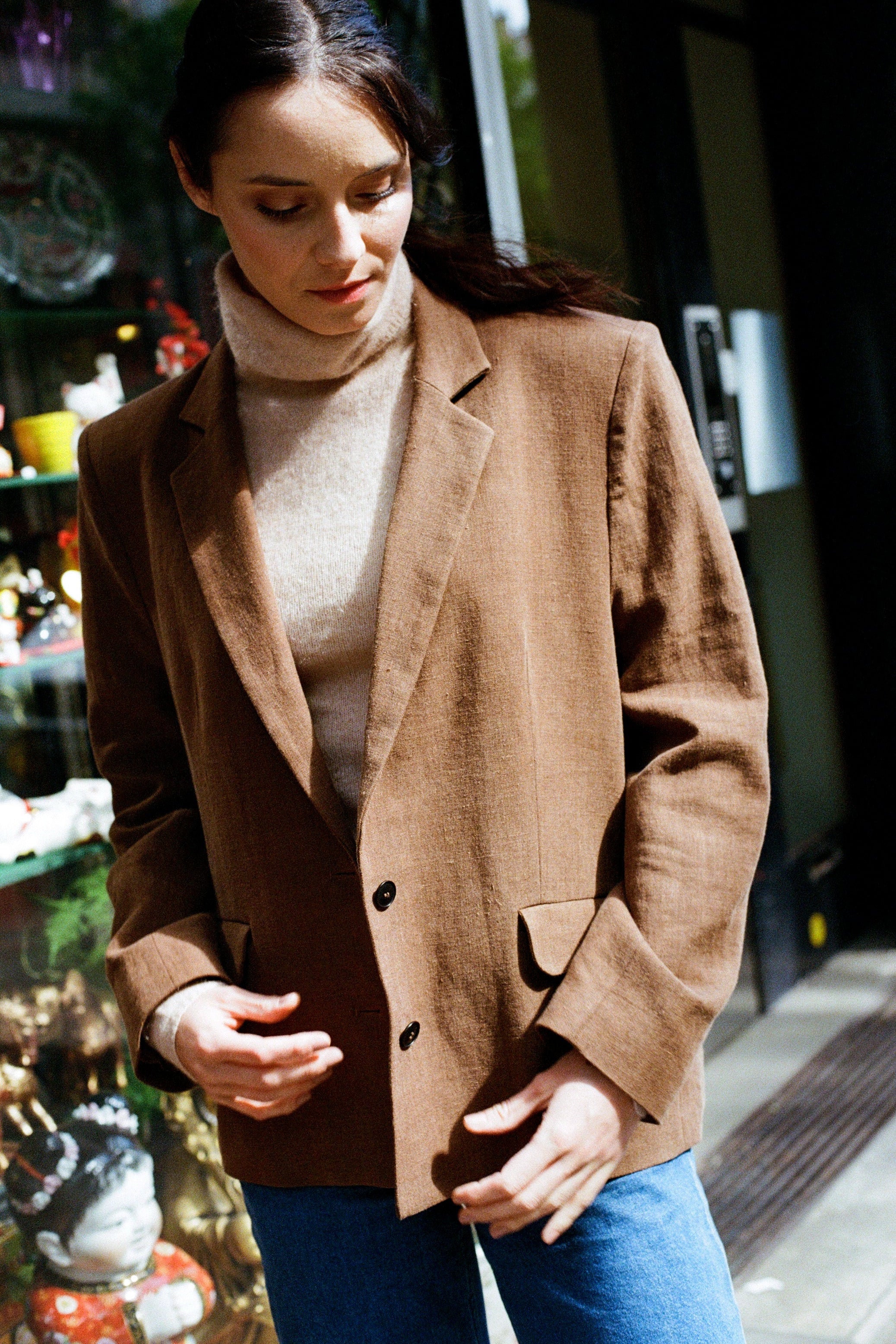 Side profile of oversized tan blazer, boxy blazer in a breathable linen wool blend with vented hem, relaxed wool blazer suited to autumn layering
