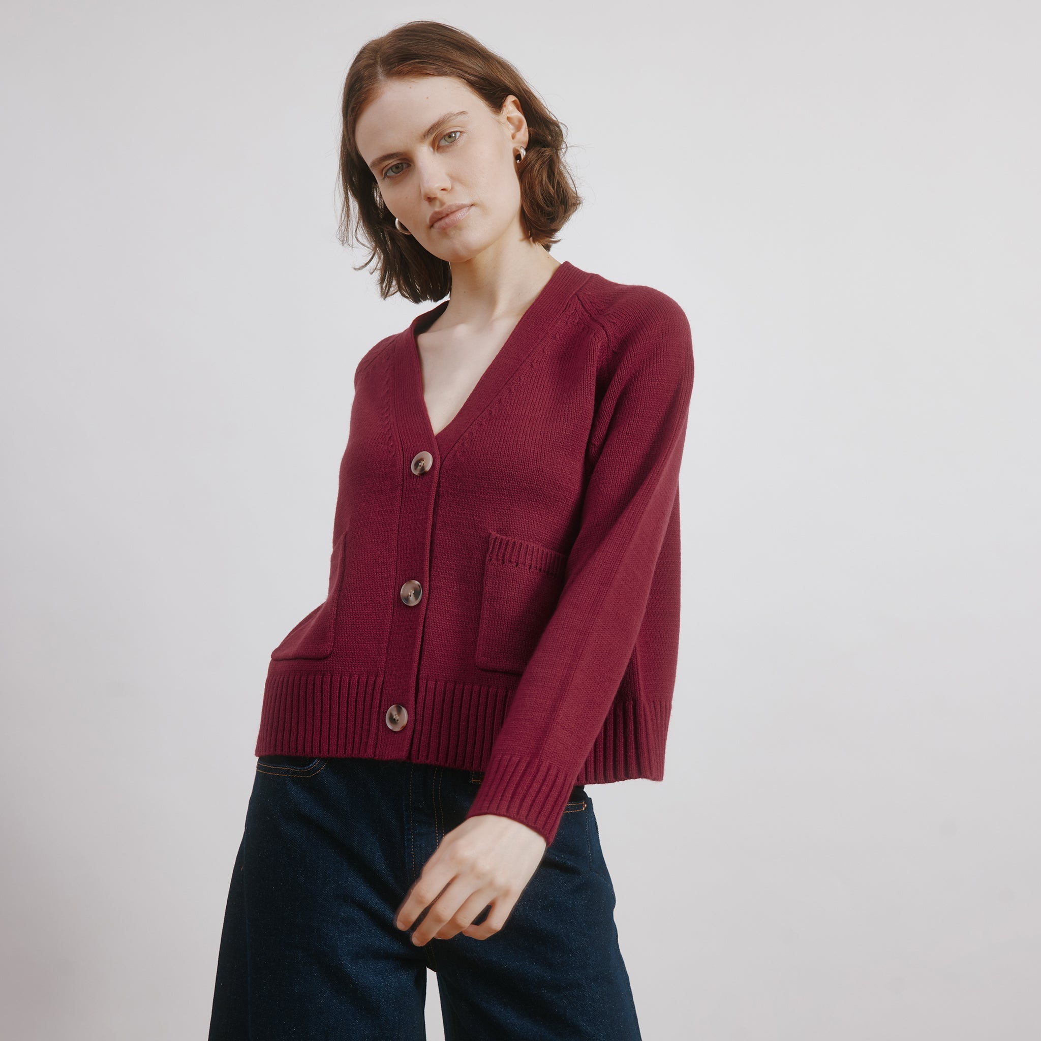 Dark red knit cardigan styled as a soft wool blend everyday cardi
