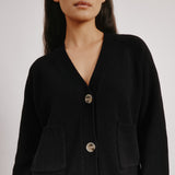 Black wool blend cardigan styled with front pockets for everyday wear