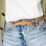 Lifestyle shot featuring handmade women's belt with biodegradable texture and rustic tones.
