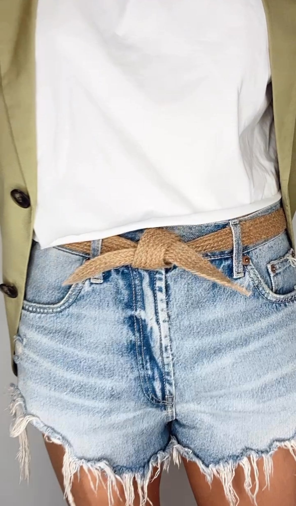 Lifestyle shot featuring handmade women's belt with biodegradable texture and rustic tones.
