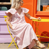 Model wearing a cotton summer dress with V-neck, ruffle neckline, and flowy A-line shape.