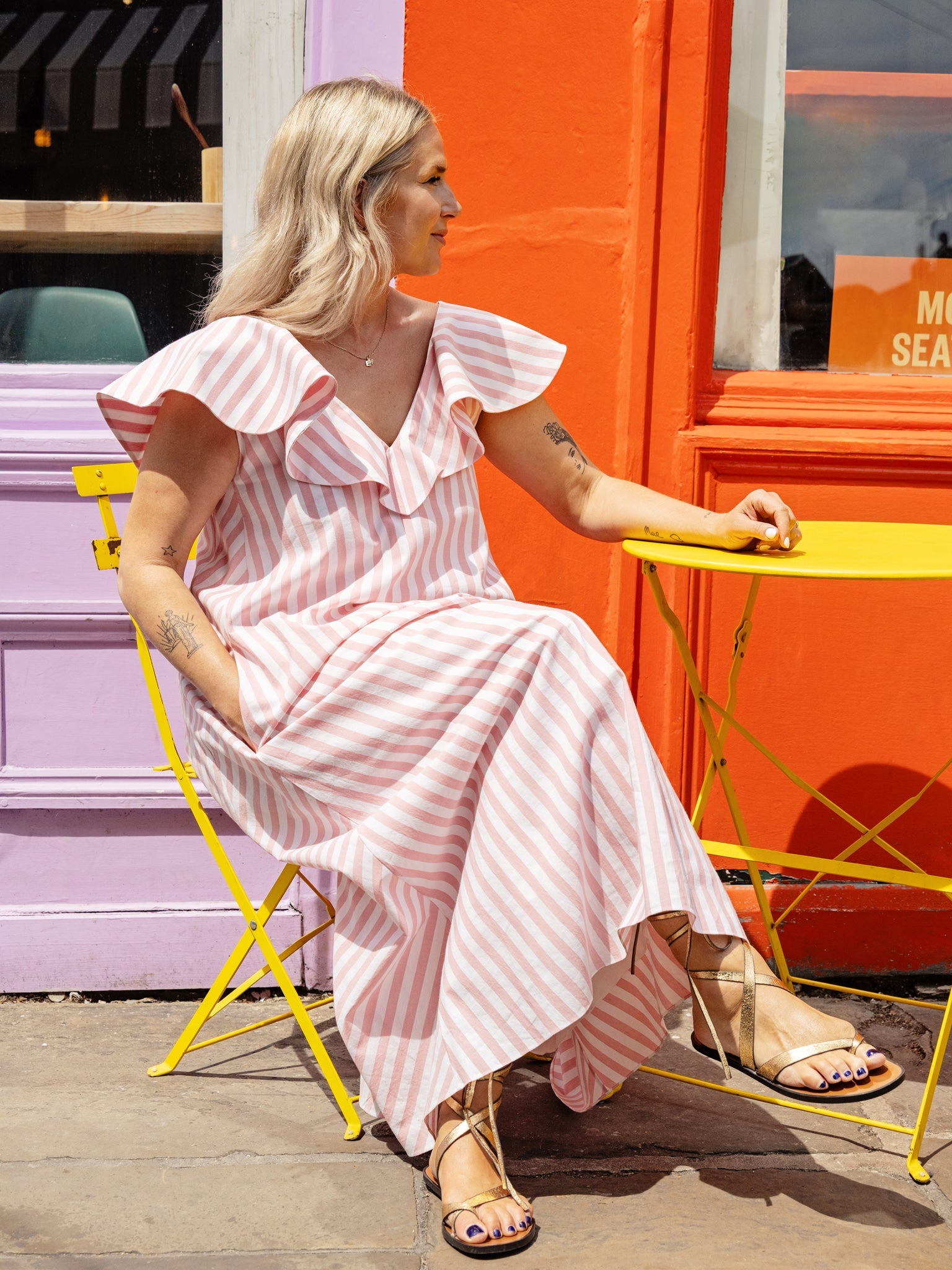 Model wearing a cotton summer dress with V-neck, ruffle neckline, and flowy A-line shape.