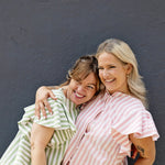 High neck blouse with ruffle sleeves, button up front, made from soft cotton fabric.