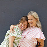 High neck blouse with ruffle sleeves, button up front, made from soft cotton fabric.