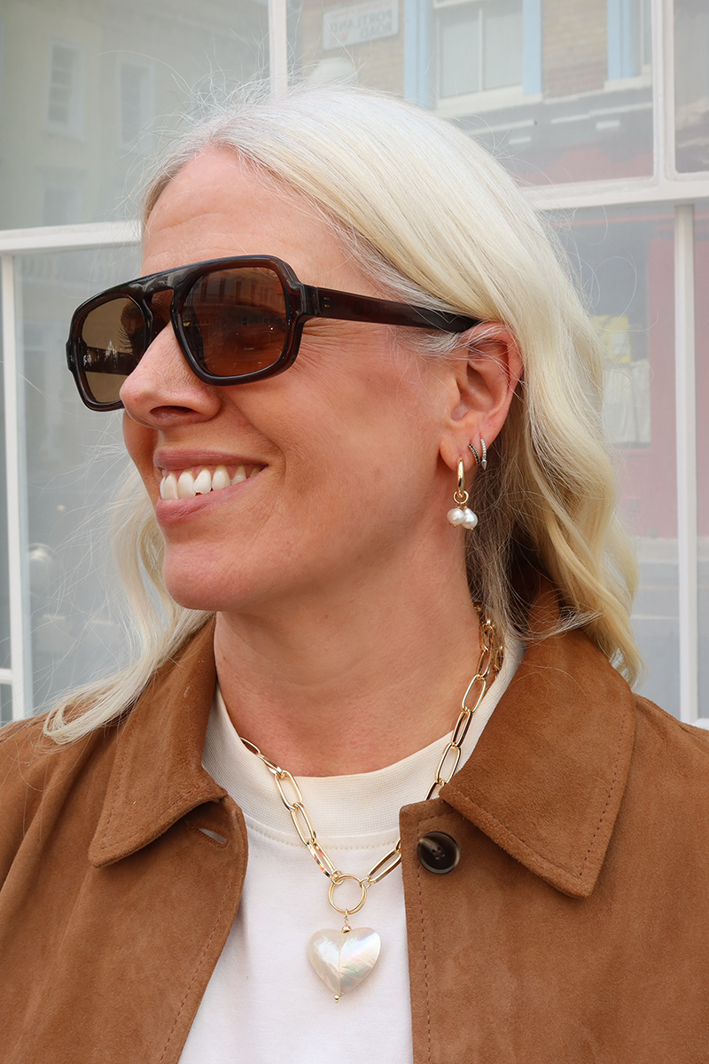 Gold plated chunky chain necklace with mother of pearl pendant for an elegant look.