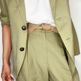 Handmade women's belt wrapped neatly, highlighting biodegradable craftsmanship.