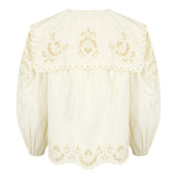 Elegant white blouse with long balloon sleeves, oversized collar, and embroidery along the cuffs.