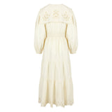 Side view of a lightweight cotton summer dress showing balloon sleeves and embroidered detailing on the bodice.