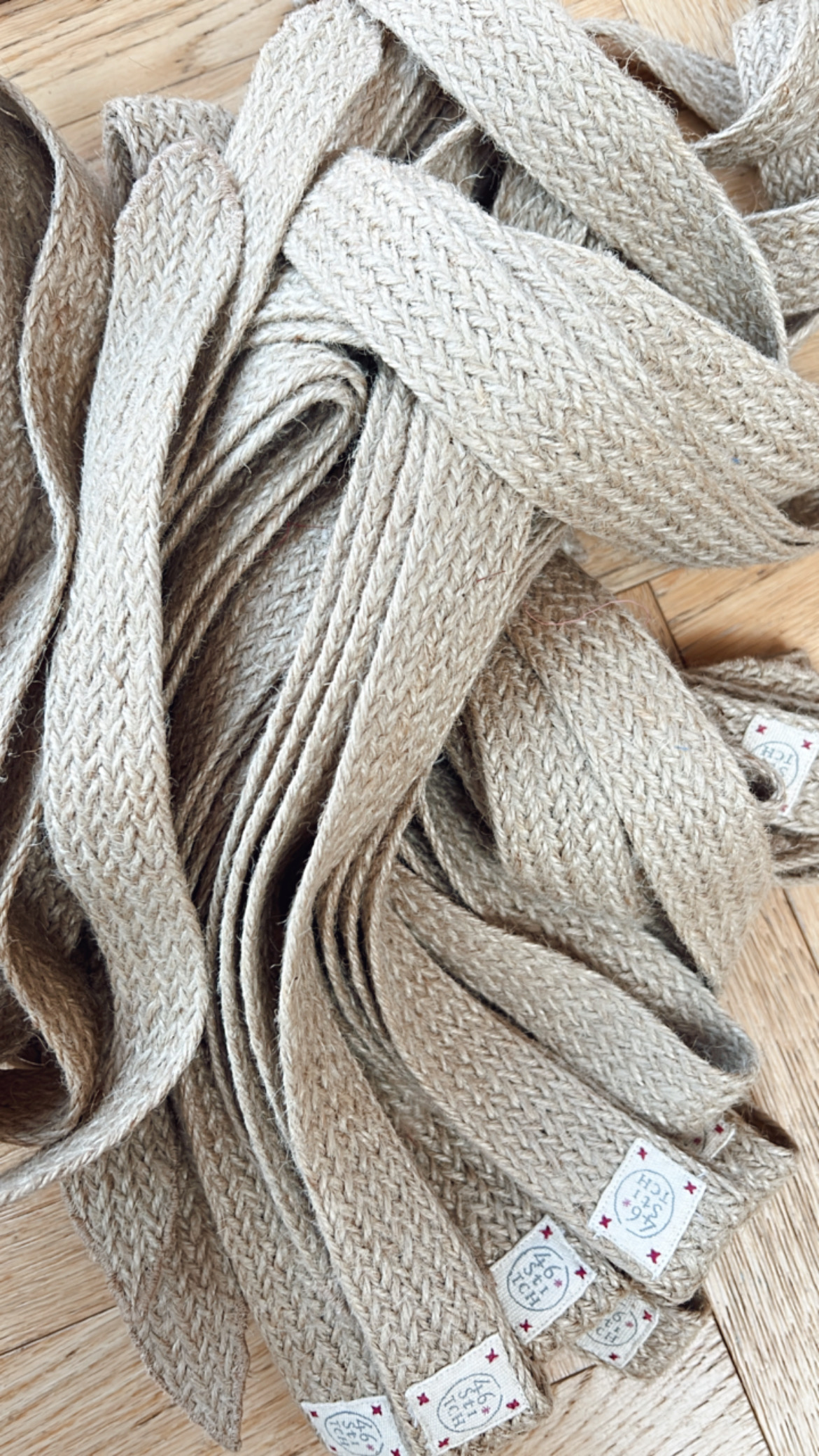 Natural fiber tie belt displayed on rustic background emphasizing eco-friendly design.