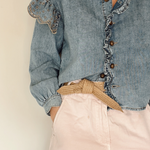 Biodegradable tie belt styled with natural light highlighting fiber details.