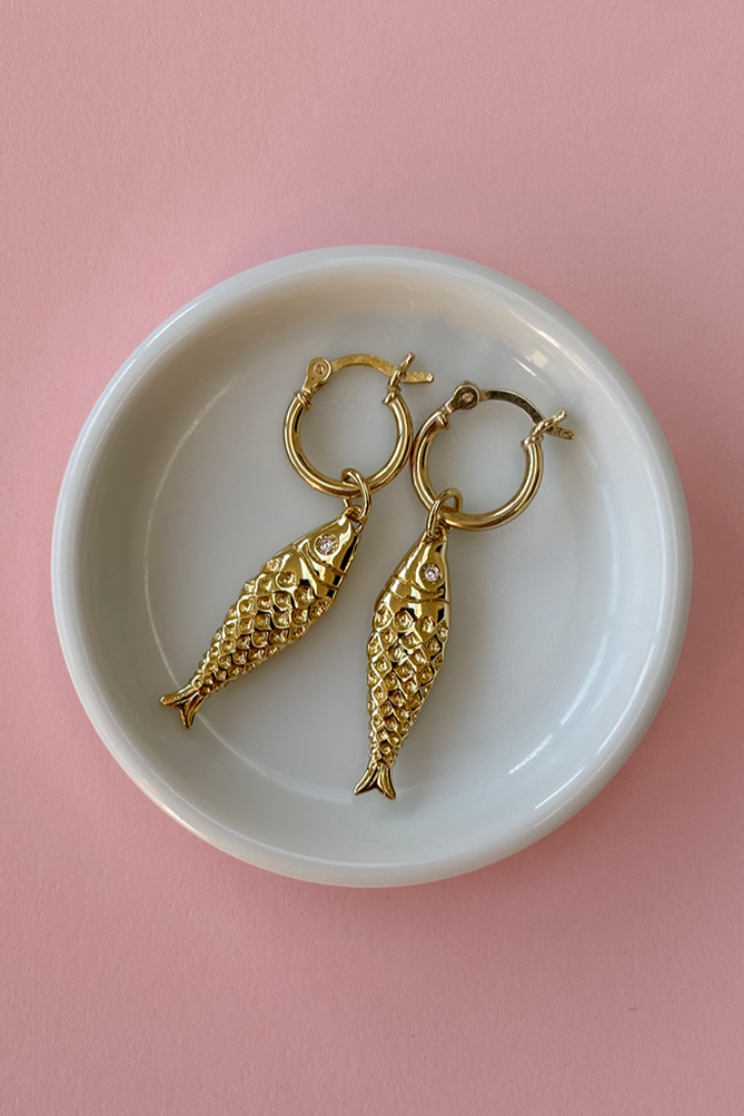 Model wearing gold plated mini hoop earrings styled with casual outfit.
