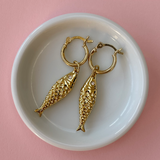 Model wearing gold plated mini hoop earrings styled with casual outfit.