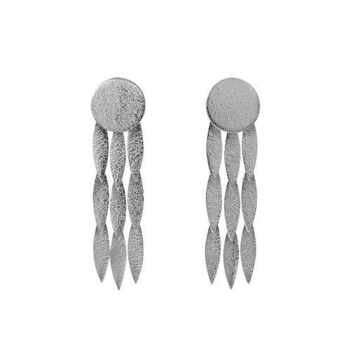 The Icarus Large Sun Drop Earrings are a contemporary statement earring with fantastic movement that shimmer in the light. The are made from sterling silver and measure 1.6cm x 6cm  Cara Tonkin designs beautiful, elegant and bold jewellery for stylish and strong-minded women. Her work marries classic and contemporary design to create unique, timeless pieces. 
