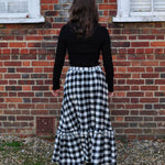 woman wearing gingham skirt back
