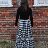 woman wearing gingham skirt back