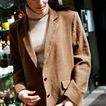 Side profile of oversized tan blazer, boxy blazer in a breathable linen wool blend with vented hem, relaxed wool blazer suited to autumn layering