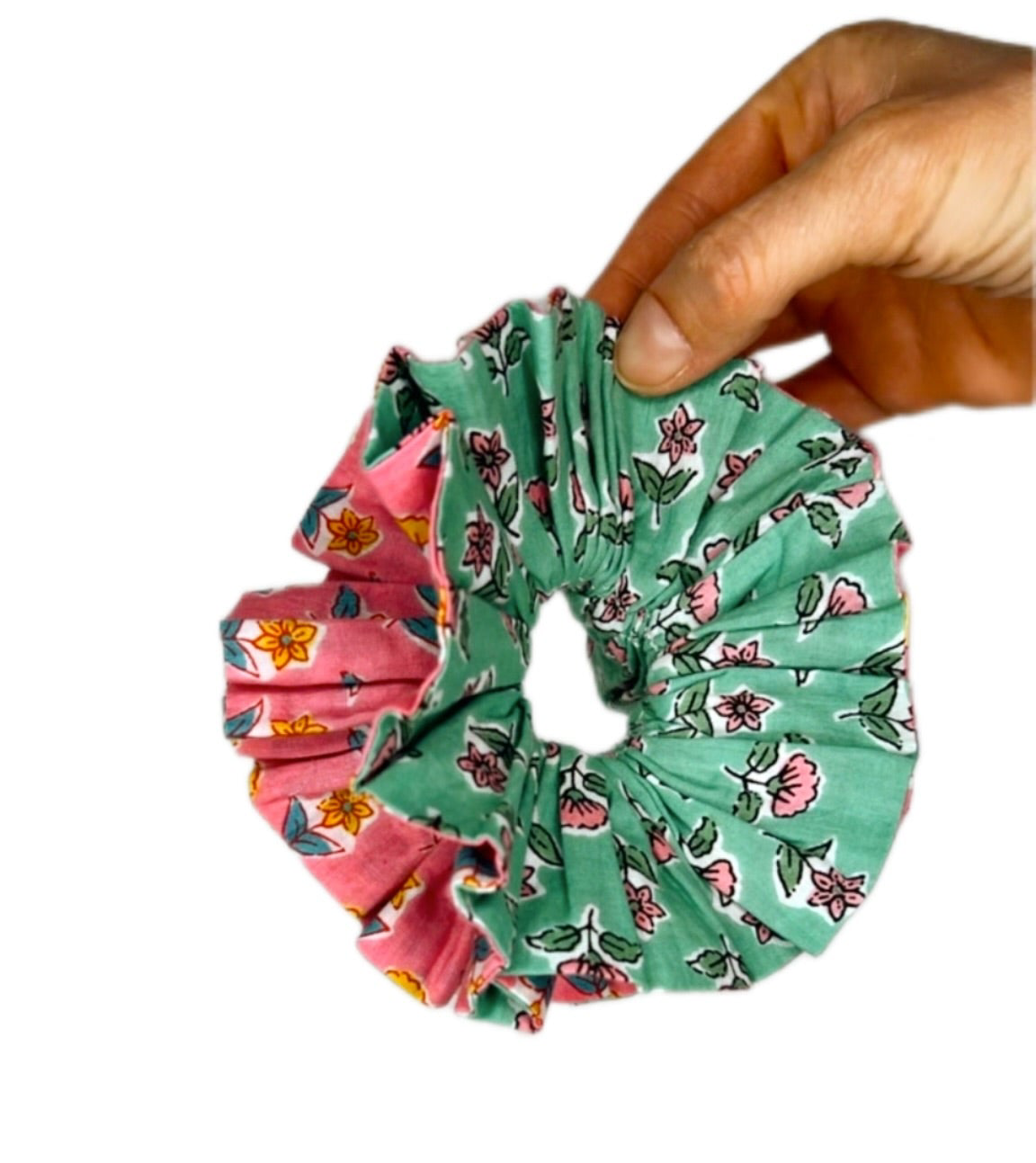 Green oversized scrunchie styled in a loose bun, highlighting the floral pattern.