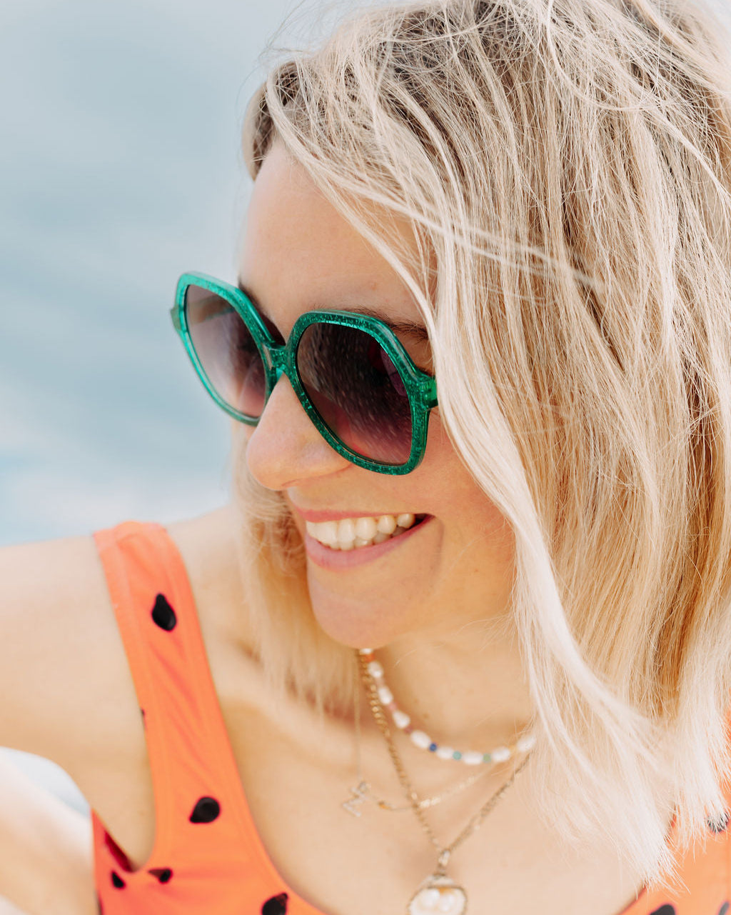 Colourful sunglasses with vibrant green frames and stylish design.