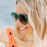 Colourful sunglasses with vibrant green frames and stylish design.