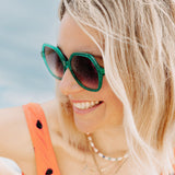 Colourful sunglasses with vibrant green frames and stylish design.