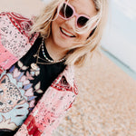 Close-up of pink colourful sunglasses highlighting the vibrant frame details.