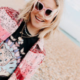 Close-up of pink colourful sunglasses highlighting the vibrant frame details.