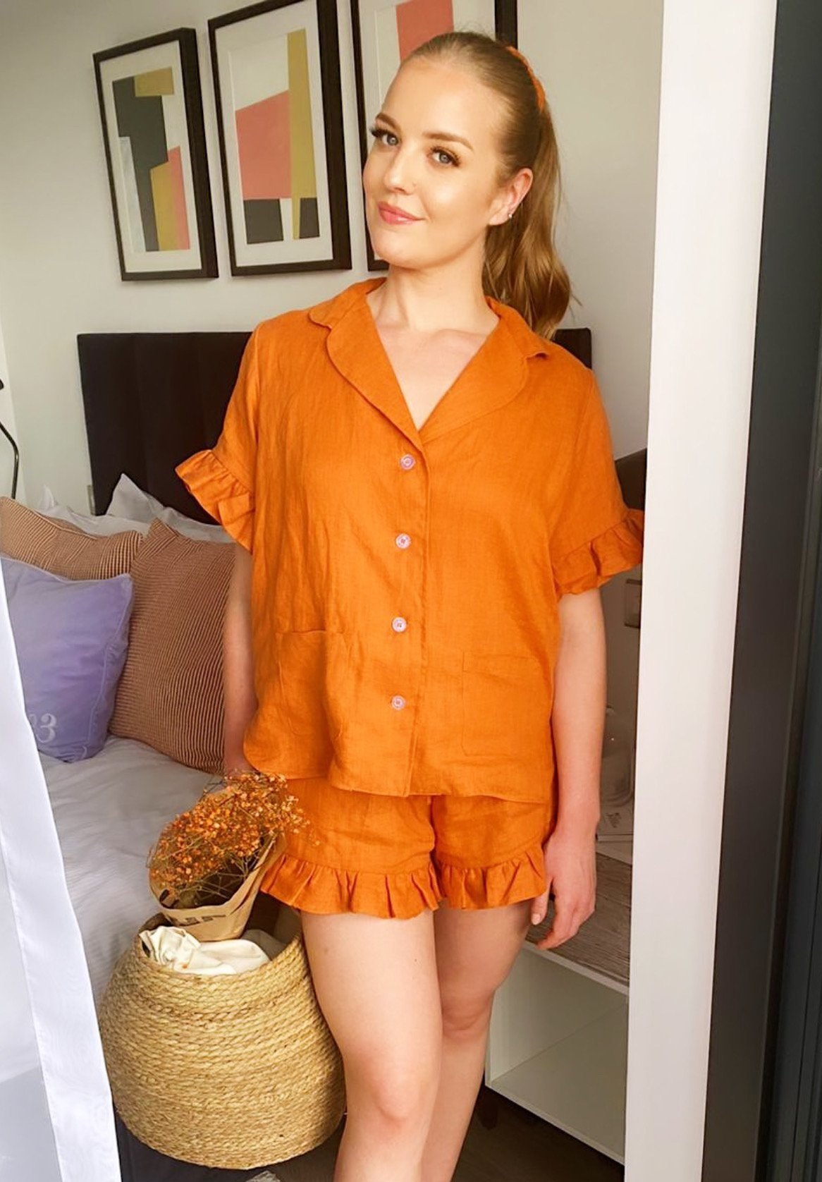 Short sleeve button up linen shirt with frill sleeves paired with high waisted linen shorts.