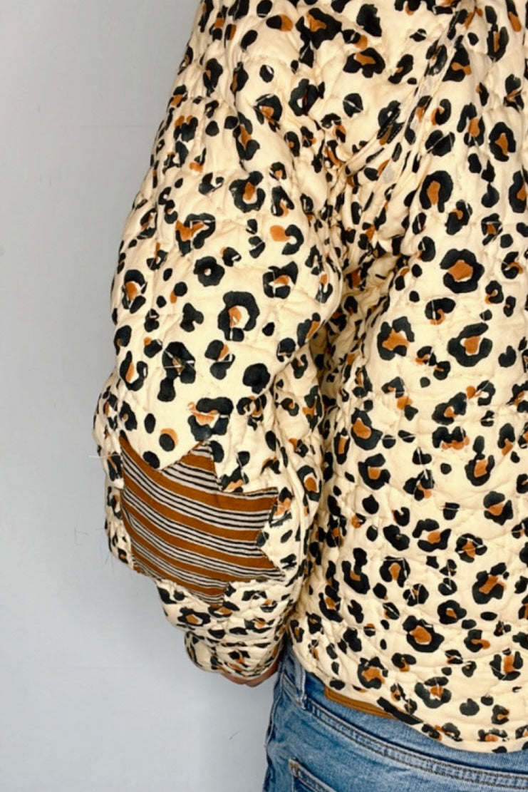 Woman posing in an animal print cotton jacket with tie front and relaxed silhouette.