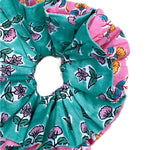 Oversized green floral scrunchie with large fabric folds for a statement look.