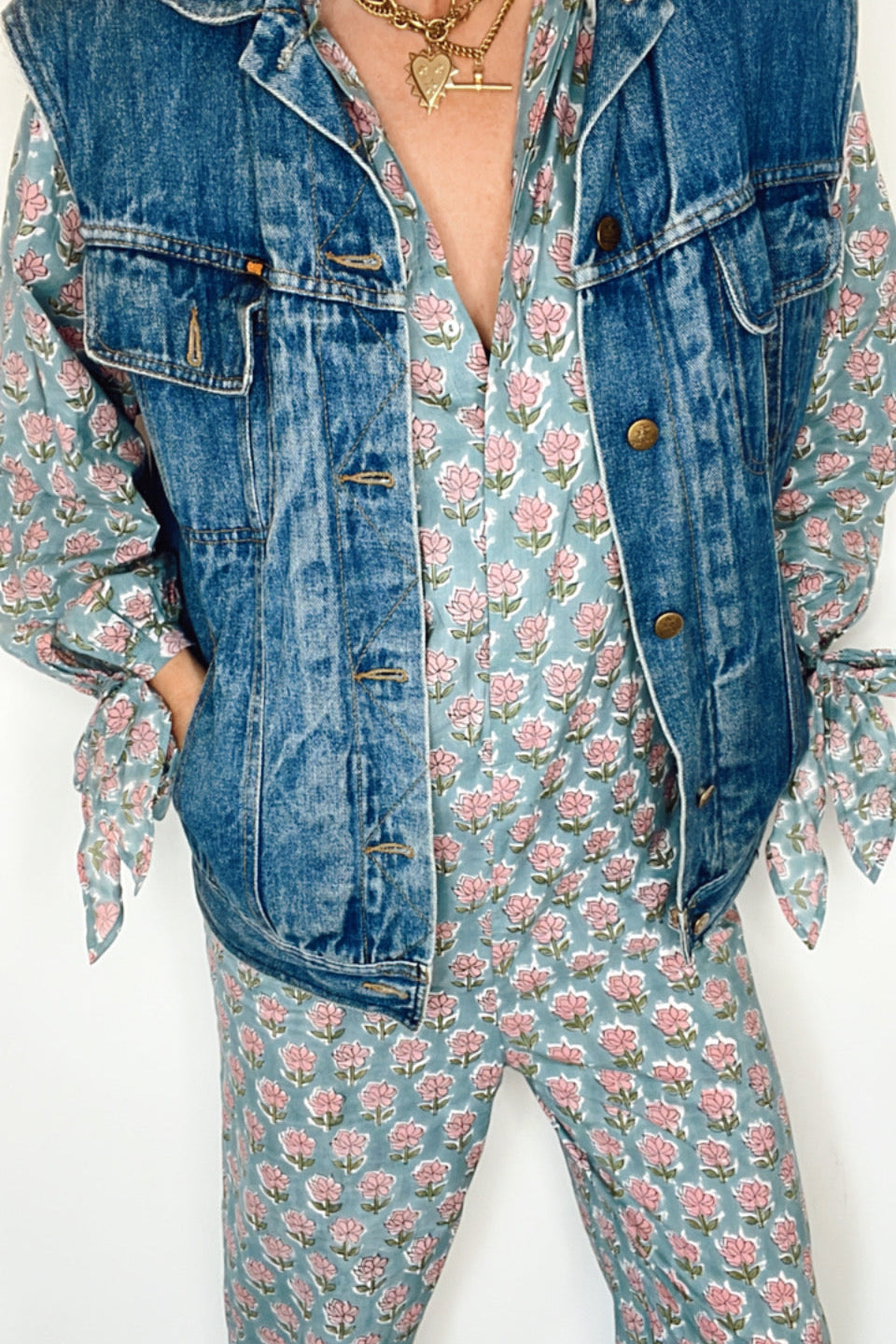 Flowing blue jumpsuit with balloon sleeves, tie cuffs, and a flattering V neck design.