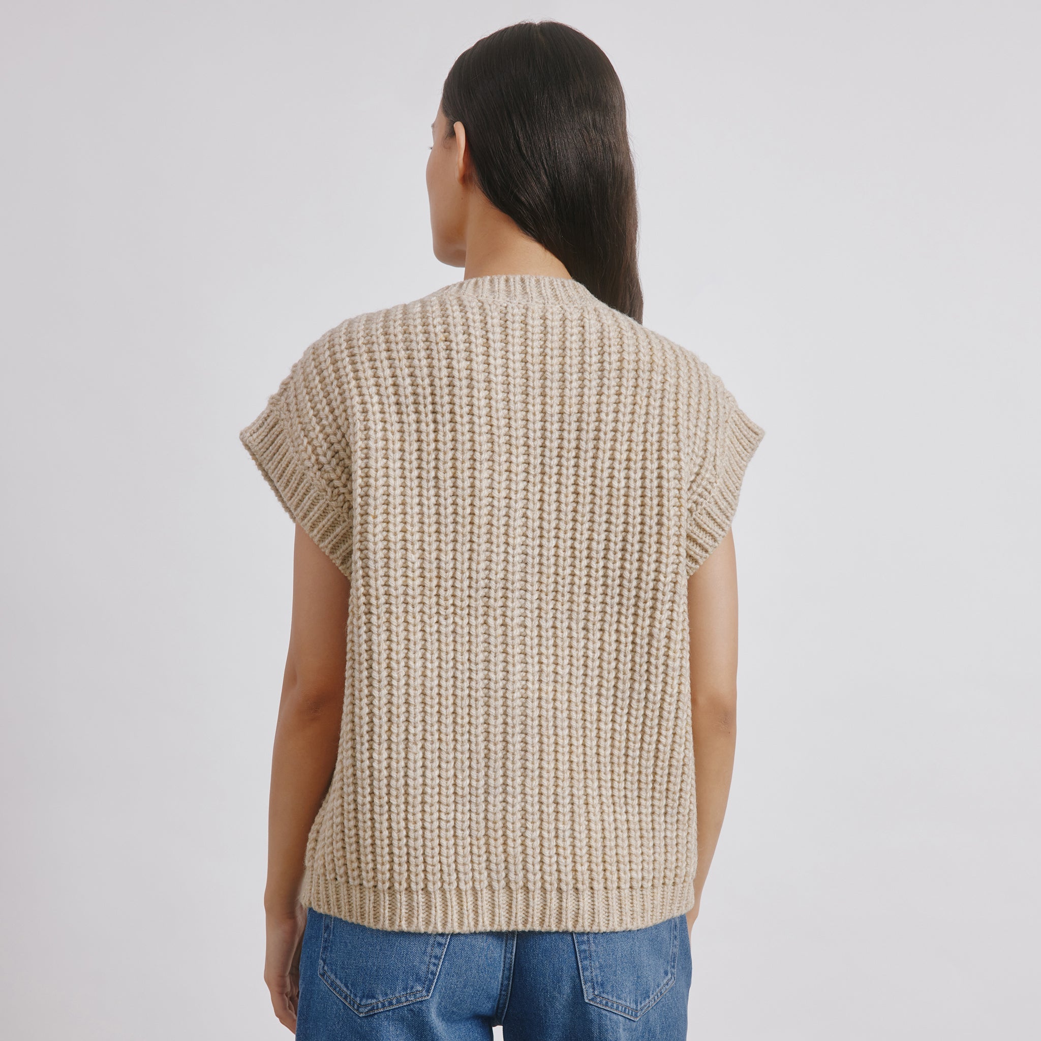 Beige knit waistcoat with ribbed texture and horn button details, sleeveless wool blend vest perfect for cosy autumn layering