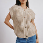 Close-up of beige ribbed wool blend waistcoat with V-neck and chunky knit, sustainable and versatile layering piece for cooler weather