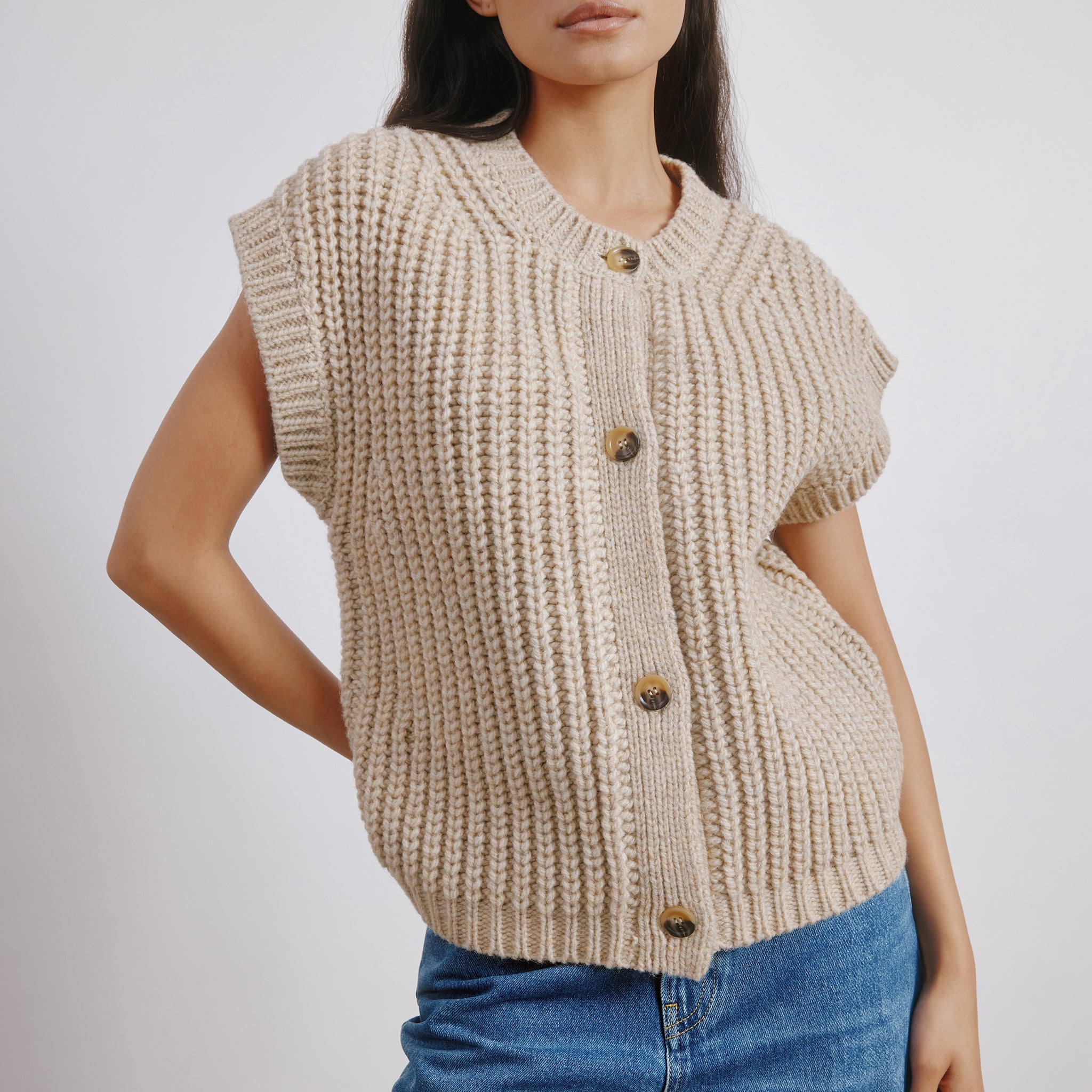 Close-up of beige ribbed wool blend waistcoat with V-neck and chunky knit, sustainable and versatile layering piece for cooler weather