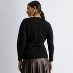 Black cocoon sleeve knit sweater with voluminous sleeves and fitted silhouette, styled with slim pants for a contemporary look, sustainable and organic cotton jumper.