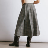 Check midi skirt with a fitted waist and deep structured pleats, creating a flattering silhouette for autumn winter.  