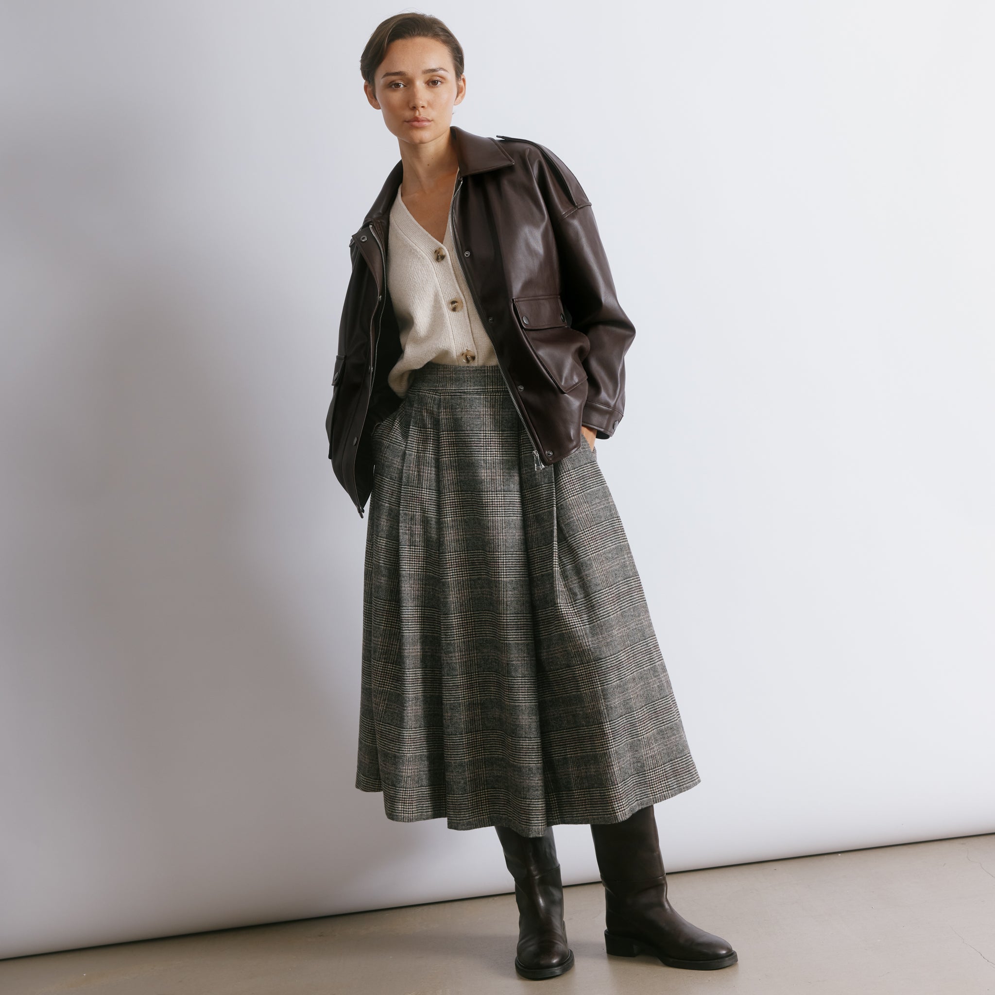 Classic check midi skirt featuring tailored pleats and a timeless fit for effortless seasonal styling.  