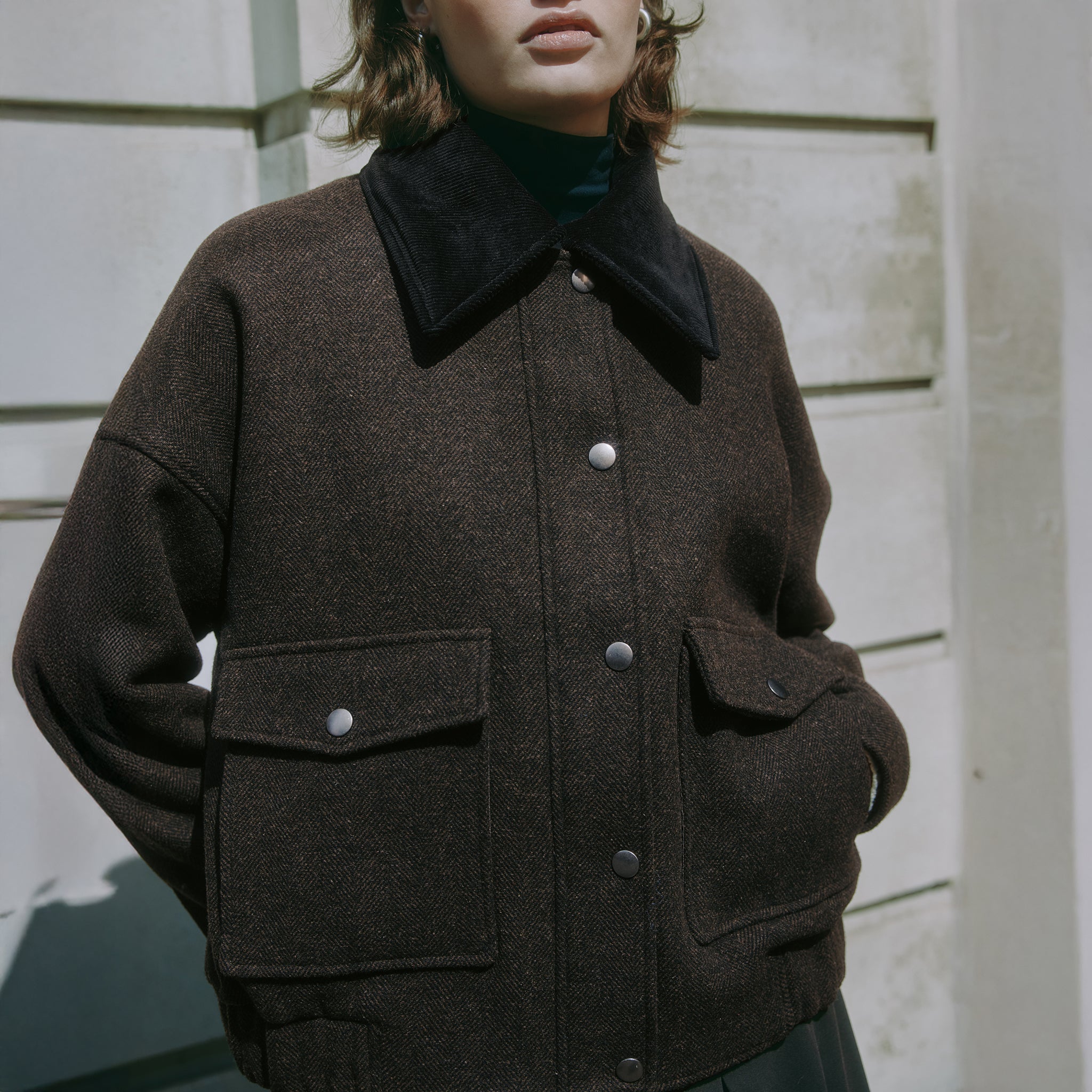 Brown flannel jacket with removable collar styled as versatile outerwear  