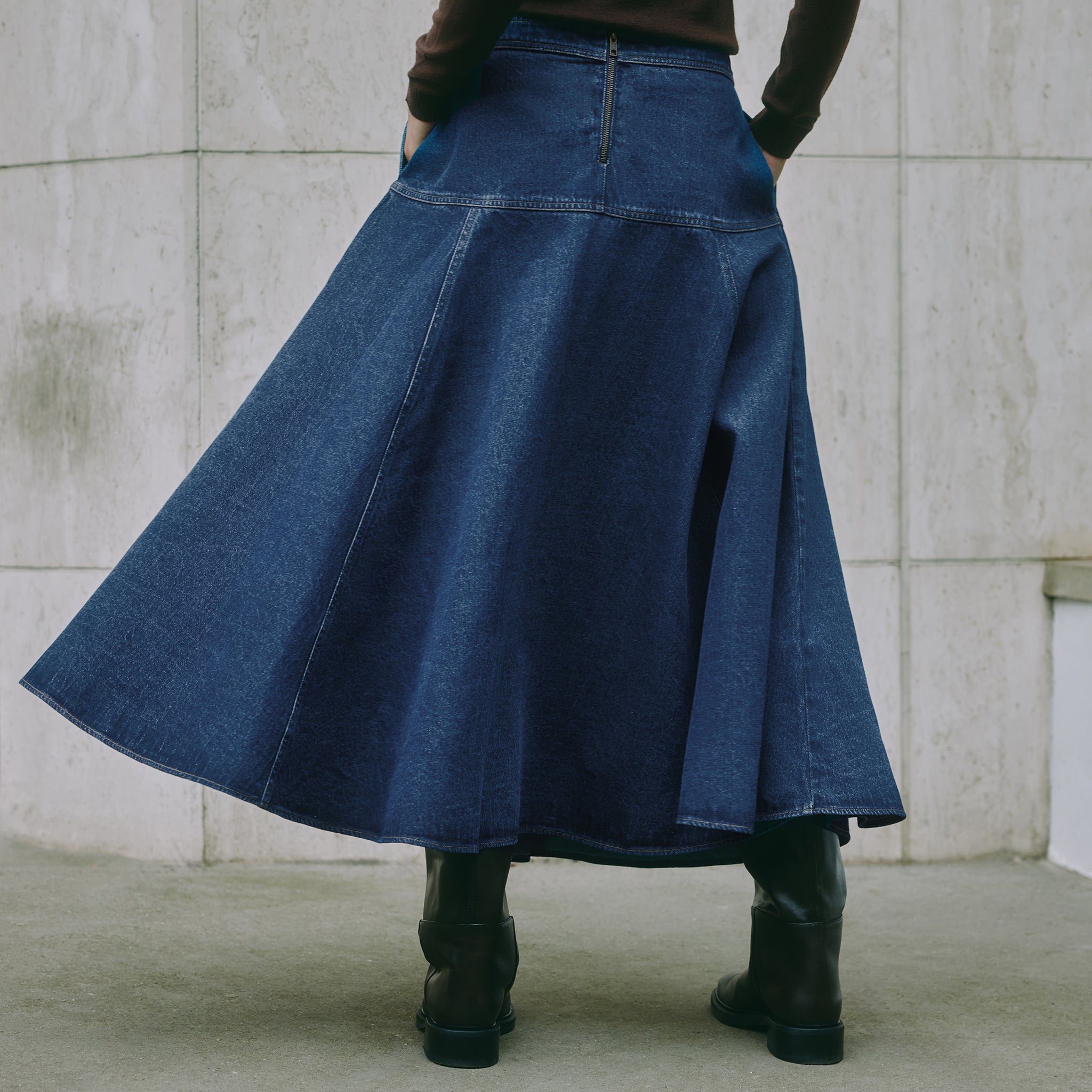Indigo denim skirt with basque waist and contrast stitching, A-line midi length, made from organic cotton for a sustainable and ethically made skirt.