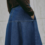 Casual A-line indigo denim skirt showing drop waist and detailed contrast stitching, highlighting eco-friendly sustainable denim.