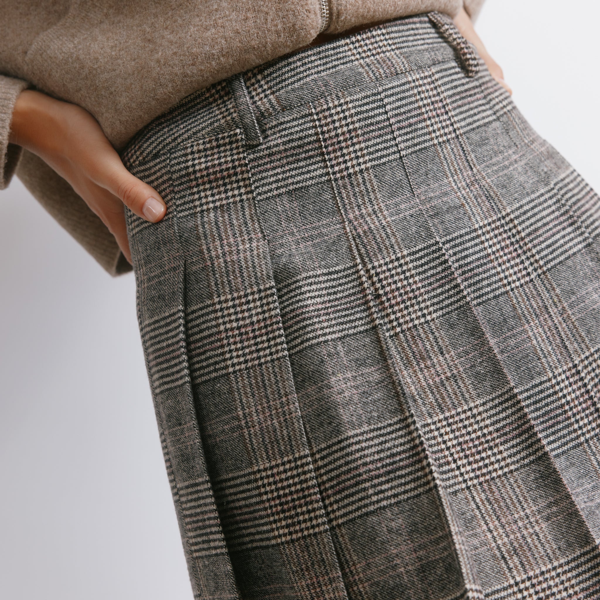 Checked wool pleated skirt in a mini length, designed for versatile winter styling and a tailored finish.
