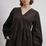 side view of brown cord mini dress with blouson sleeves and organic cotton fabric  