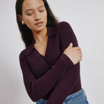 Burgundy knit top worn by model with high neckline and tonal buttons, slim fit rib sweater style, perfect for layering or standalone wear
