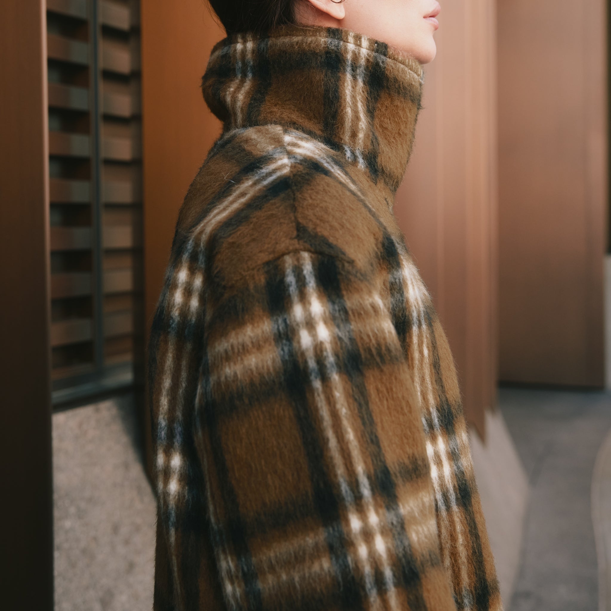Statement wool overcoat showcasing the black cream tan check pattern, ideal as a relaxed fit outerwear layer.  