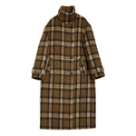 Long check wool jacket styled as an oversized winter coat with structured funnel neck and soft tailored shape.
