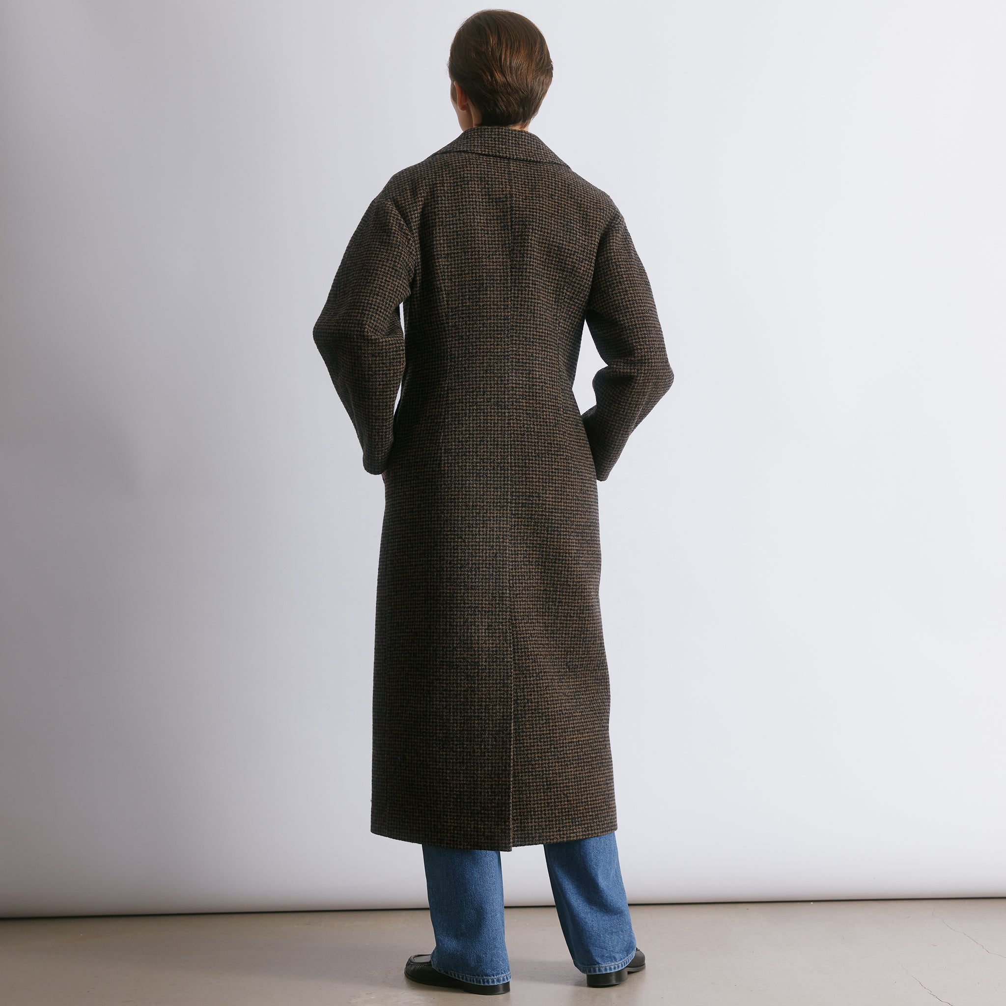 Oversized tweed wool coat with cocoon sleeves and a soft check pattern, crafted as a timeless winter outerwear piece.  