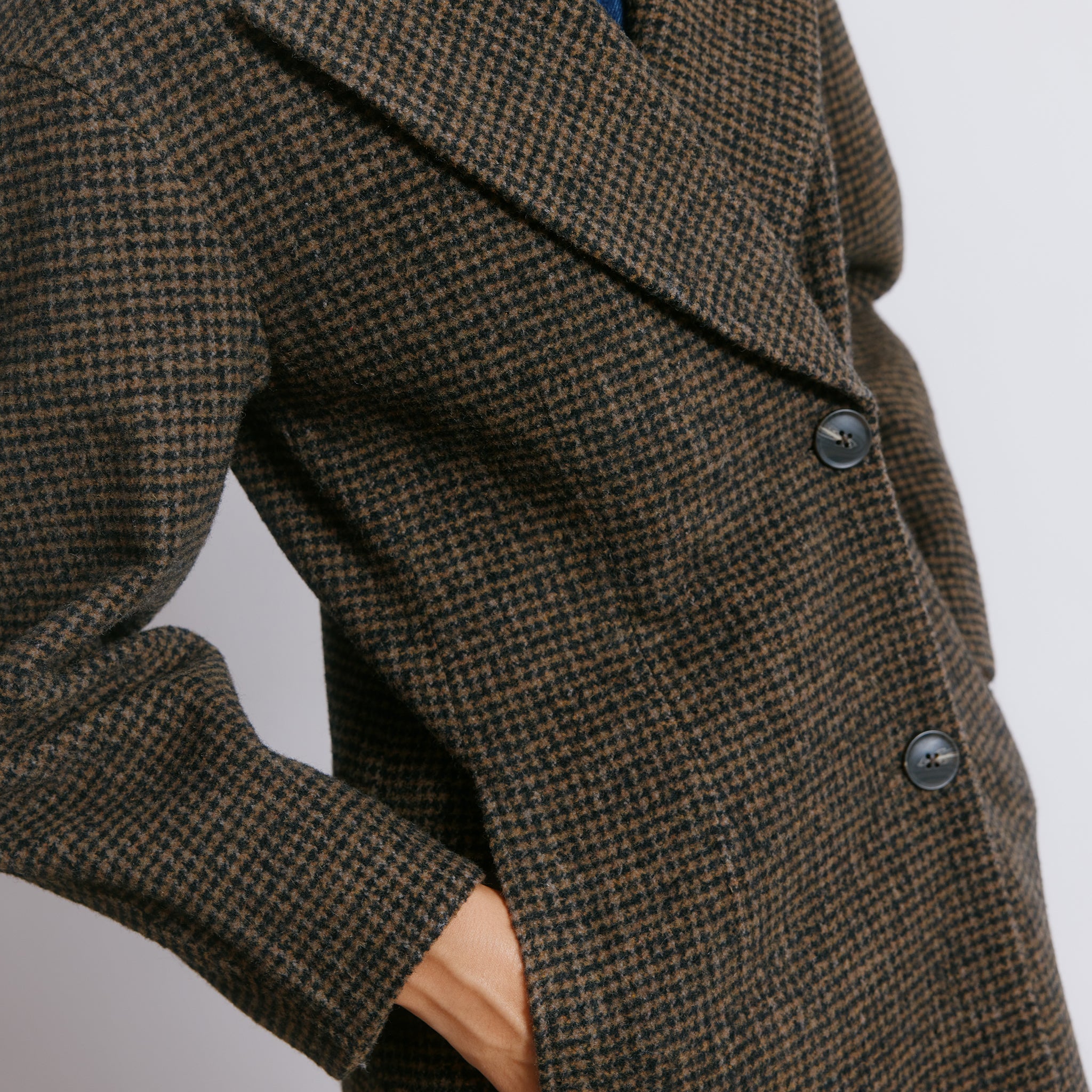 Tailored tweed wool jacket featuring horn buttons and an elegant oversized silhouette.  