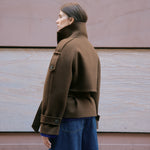 Chocolate short jacket crafted from a soft wool blend with a modern funnel neck and relaxed cropped silhouette.  