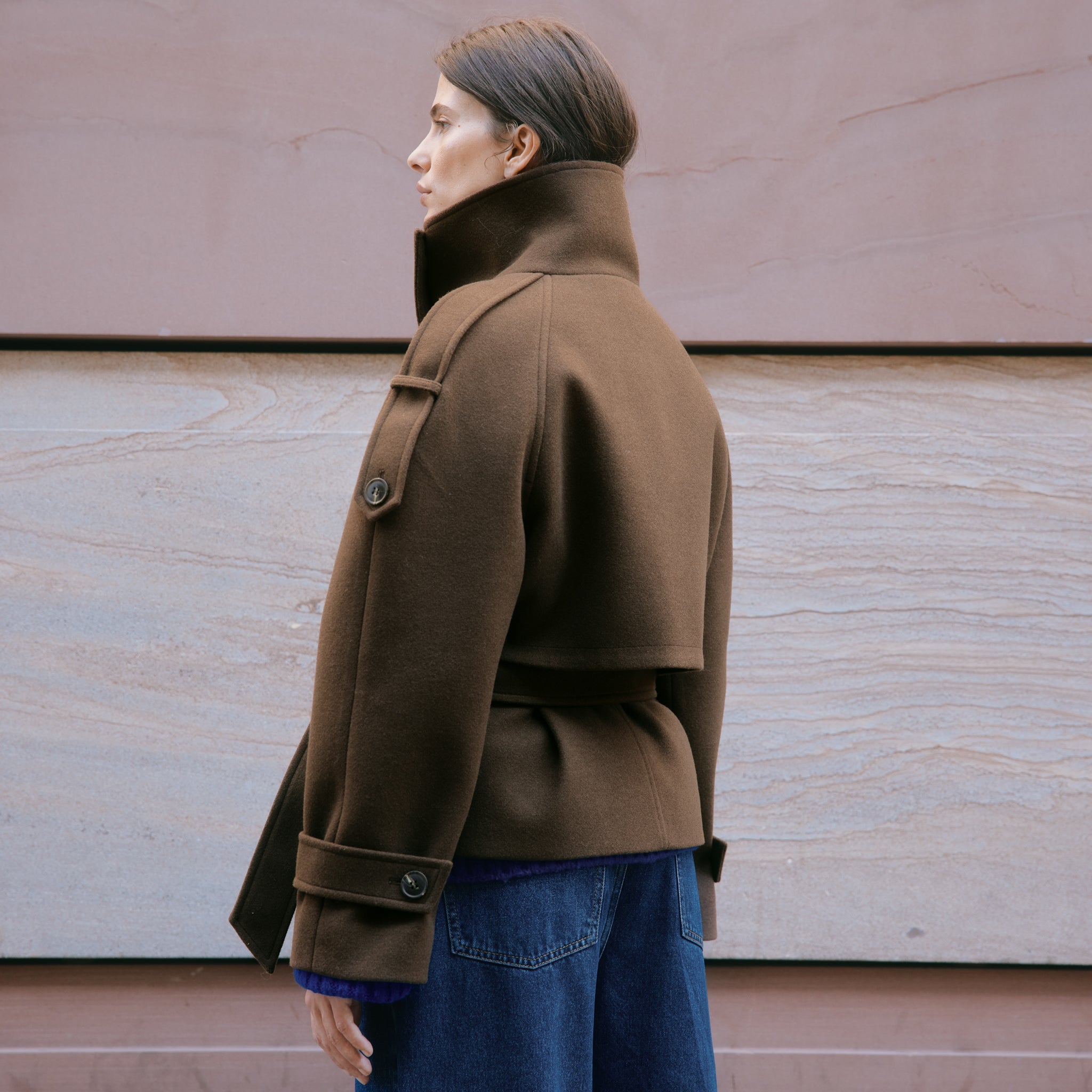 Chocolate short jacket crafted from a soft wool blend with a modern funnel neck and relaxed cropped silhouette.  