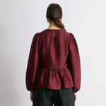 Crinkle satin blouse in burgundy with long sleeves and peplum shape  